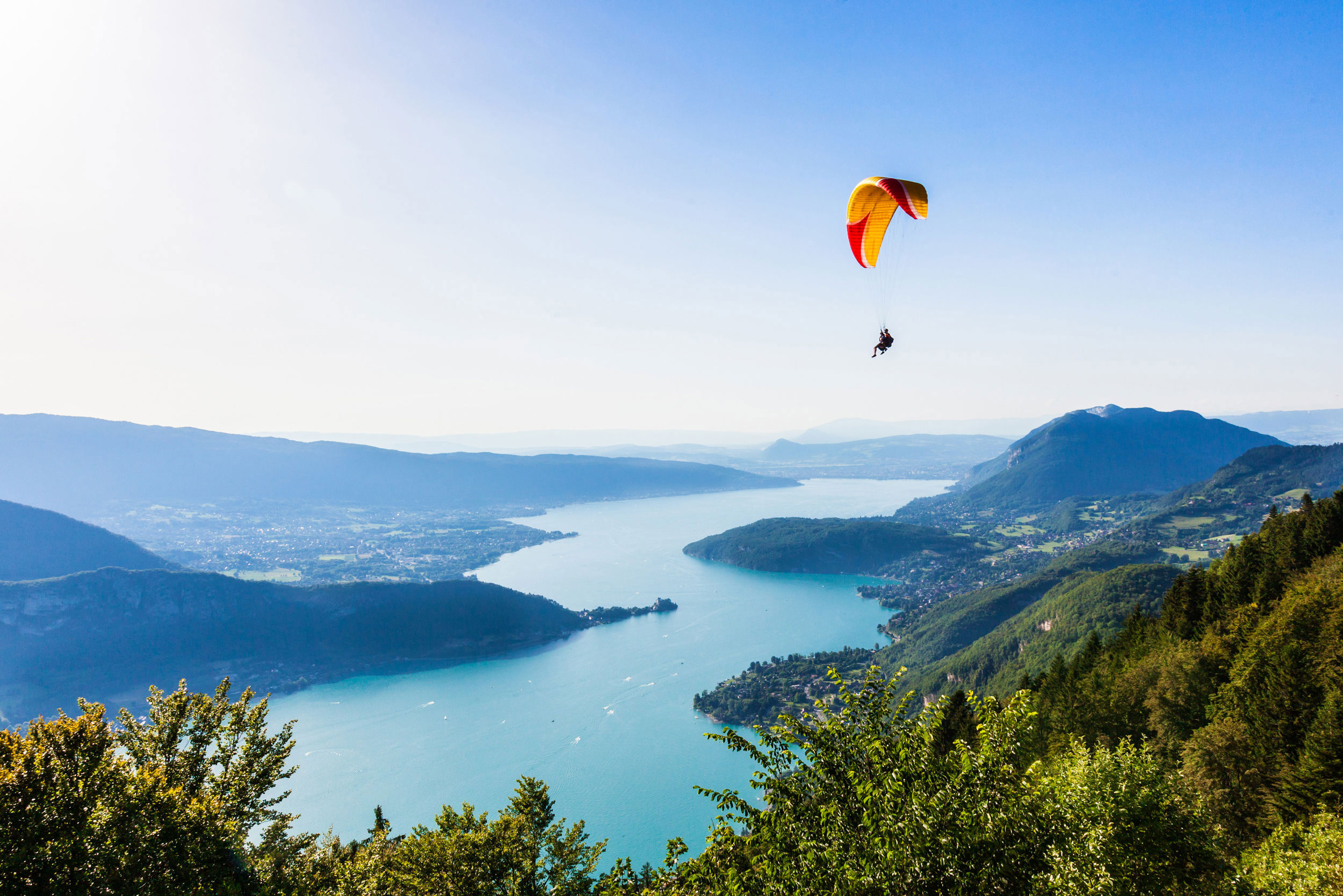 Paraglider flying above Lake Garda