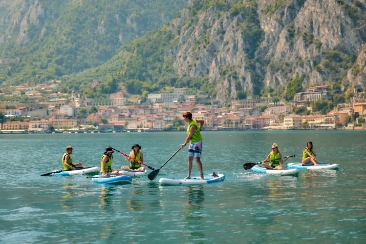Stand-up paddleboarding group close to the shore of Lake Garda
